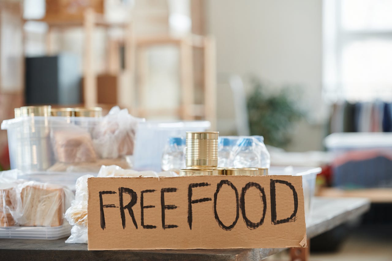 gallery-01 Indoor view of a donation table with free food and canned goods.